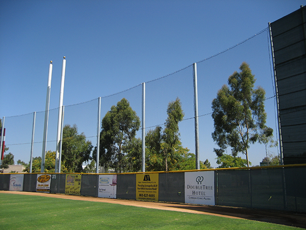 Judge Netting Barrier Specialists: A baseball field with a barrier netting for ball containment.