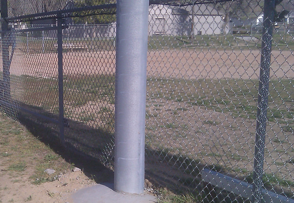 Judge Netting Barrier Specialists: A baseball field with a fence and a sports field netting barrier.