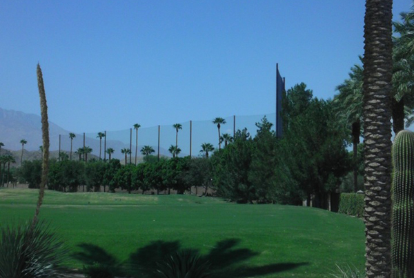 Judge Netting Barrier Specialists: A golf course in Palm Springs with palm trees and driving range netting.