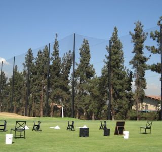 Judge Netting Barrier Specialists: A group of chairs are set up on a golf course, surrounded by sports field netting barriers.