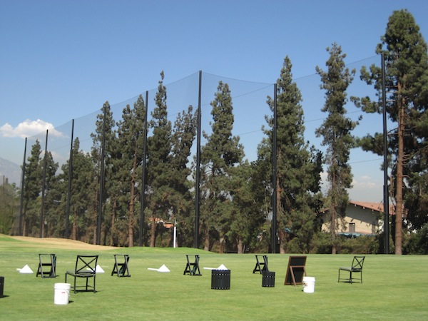 Judge Netting Barrier Specialists: A group of chairs are set up on a golf course, surrounded by sports field netting barriers.