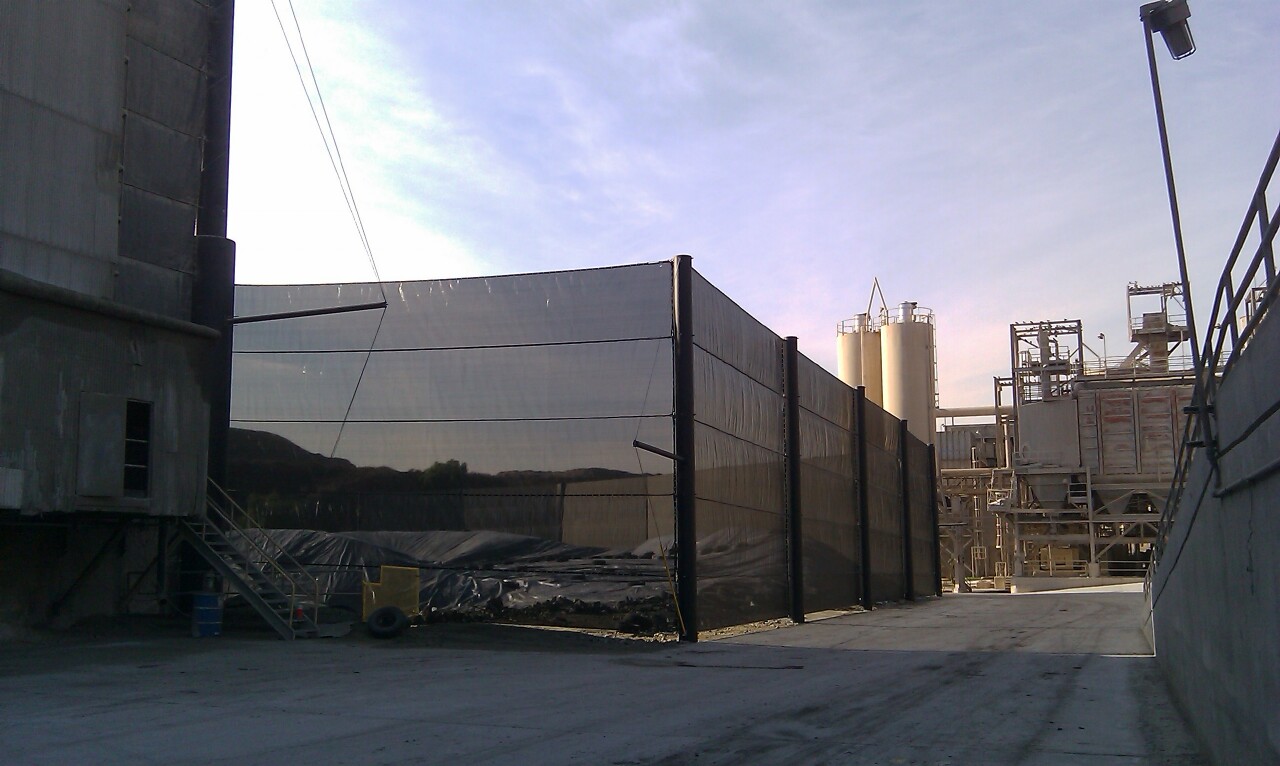 Judge Netting Barrier Specialists: A black netting fence industrial containment barrier.