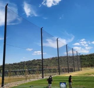 Close-up of a steel support pole anchoring the new driving range netting at Eagle Glen Golf Course