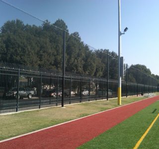 Judge Netting Barrier Specialists: A barrier with red and yellow stripes.