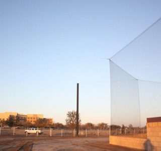 Judge Netting Barrier Specialists: A baseball field with a net used for landfill netting barriers and protecting the golf course.