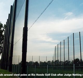 Pole pads installed on steel poles at Rio Hondo Golf Club with upgraded industrial netting against a cloudy sky.